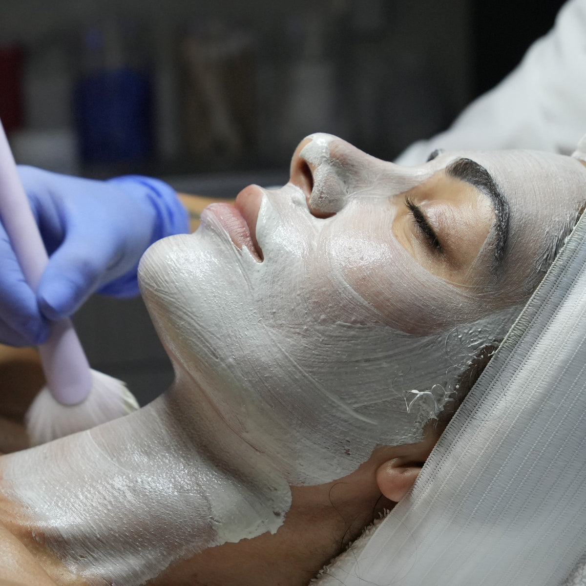 Side profile of a client receiving a professional face mask treatment at MDR Skin Studio, a premium clinical skincare clinic in Brickell, Miami.